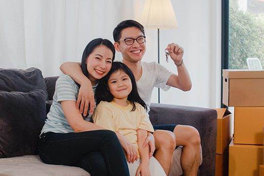 Family holding the keys to their new home